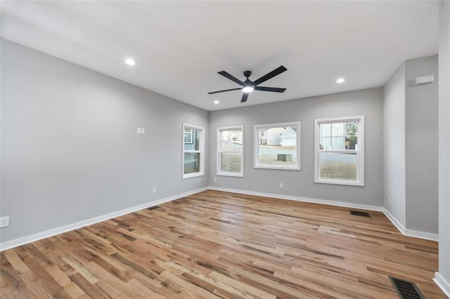 unfurnished room with baseboards, visible vents, wood finished floors, and recessed lighting