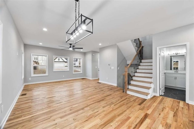 interior space featuring light wood finished floors, ceiling fan, stairs, and recessed lighting