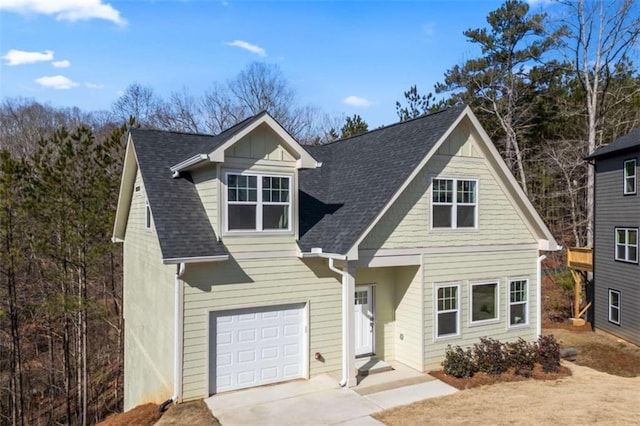 view of front of home featuring concrete driveway and roof with shingles