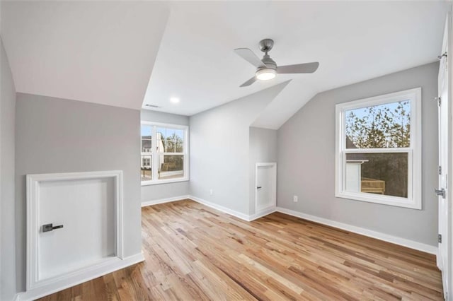 bonus room featuring visible vents, baseboards, a ceiling fan, lofted ceiling, and light wood-style floors