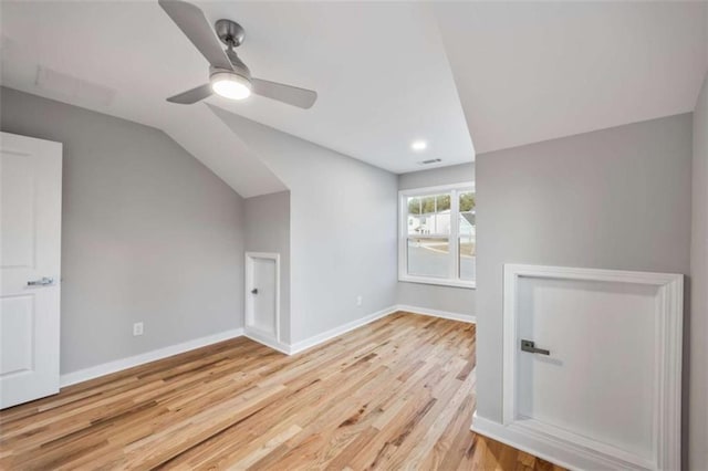 additional living space featuring light wood-type flooring, ceiling fan, lofted ceiling, and baseboards