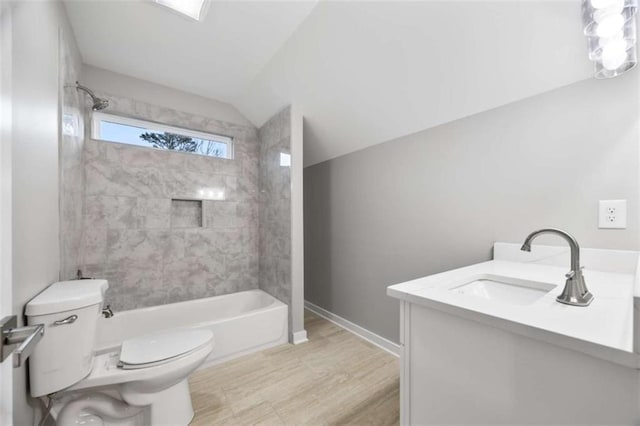 full bathroom with baseboards, toilet, vanity, vaulted ceiling, and shower / bathtub combination