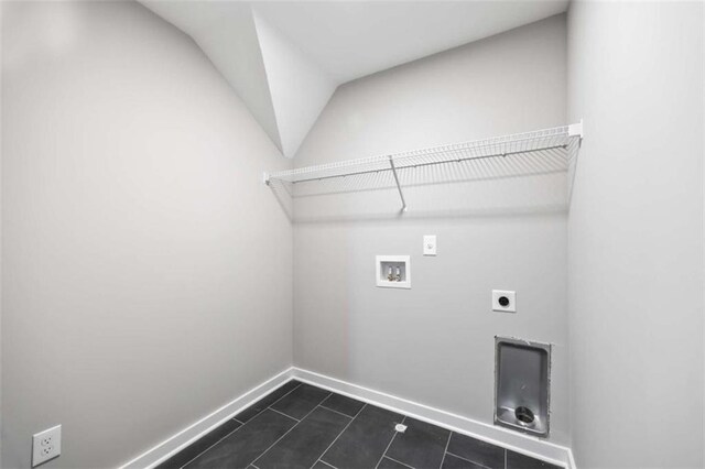 laundry area with laundry area, dark tile patterned floors, washer hookup, baseboards, and electric dryer hookup