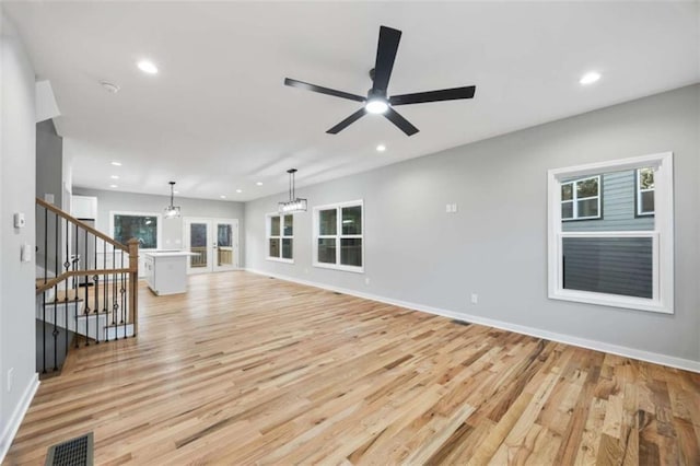 unfurnished living room with light wood finished floors, visible vents, and recessed lighting