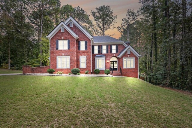 view of front of property with a lawn and french doors