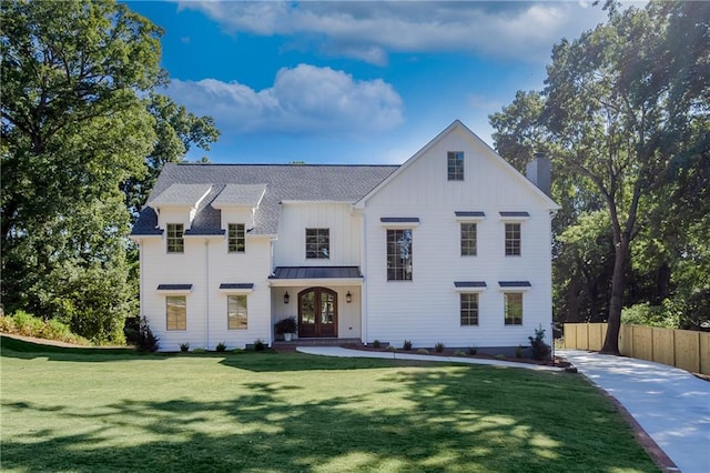 modern farmhouse style home with a front yard