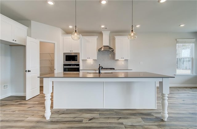 512 Dolce Rd, Locust Grove, GA 30248 - kitchen featuring a sink, wall chimney range hood, baseboards, and appliances with stainless steel finishes