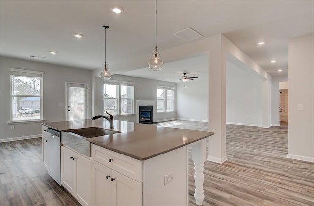 512 Dolce Rd, Locust Grove, GA 30248 - kitchen with light wood-style flooring, a sink, open floor plan, stainless steel dishwasher, and ceiling fan