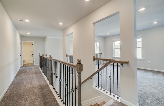 512 Dolce Rd, Locust Grove, GA 30248 - hall featuring baseboards, an upstairs landing, visible vents, and carpet floors