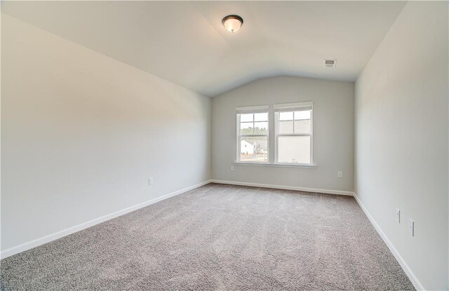 512 Dolce Rd, Locust Grove, GA 30248 - empty room featuring vaulted ceiling, light carpet, baseboards, and visible vents