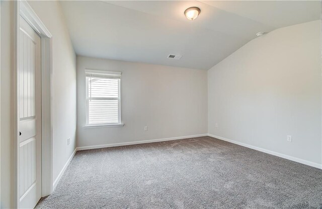512 Dolce Rd, Locust Grove, GA 30248 - empty room featuring carpet, visible vents, baseboards, and lofted ceiling