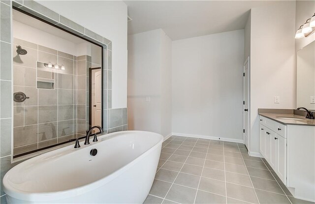 512 Dolce Rd, Locust Grove, GA 30248 - bathroom featuring baseboards, tiled shower, tile patterned flooring, vanity, and a soaking tub