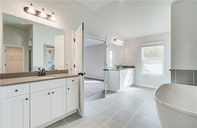 512 Dolce Rd, Locust Grove, GA 30248 - full bath with a stall shower, a sink, two vanities, tile patterned flooring, and lofted ceiling