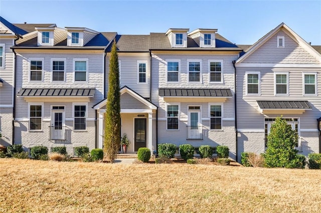 10035 River Rock Dr, Roswell, GA 30076 - view of property with a standing seam roof, brick siding, a metal roof, and a front lawn