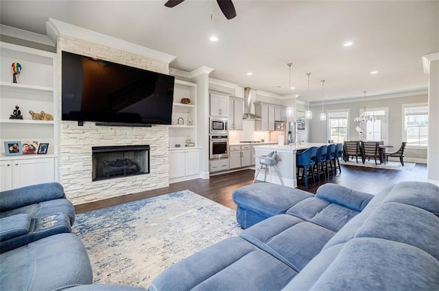10035 River Rock Dr, Roswell, GA 30076 - living room featuring ceiling fan, ornamental molding, dark wood-style flooring, a fireplace, and built in features