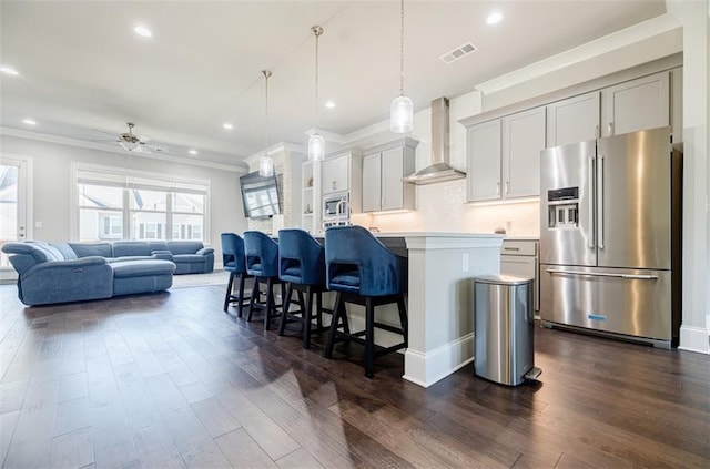 10035 River Rock Dr, Roswell, GA 30076 - kitchen with stainless steel appliances, wall chimney range hood, crown molding, plenty of natural light, and a kitchen bar