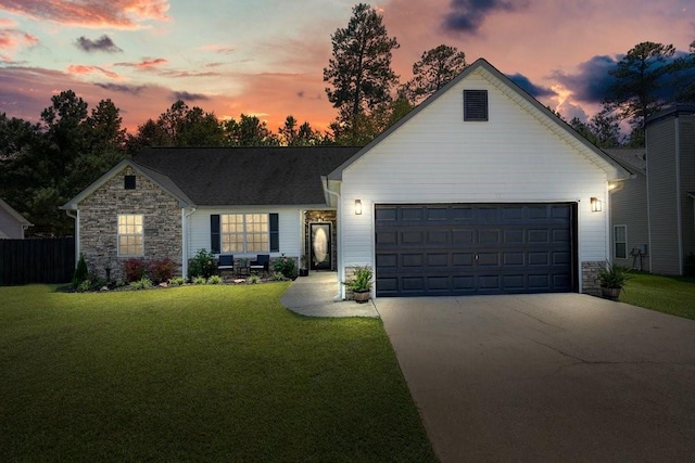 view of front of property featuring a garage and a lawn