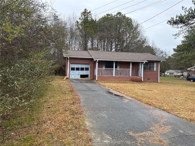 ranch-style home with a porch, a garage, and a front yard