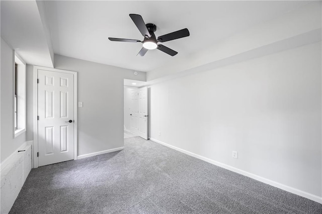 unfurnished bedroom with baseboards, carpet, and a ceiling fan