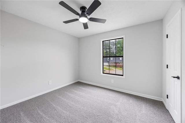 carpeted empty room with baseboards and ceiling fan
