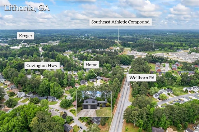 drone / aerial view featuring a view of trees and a residential view