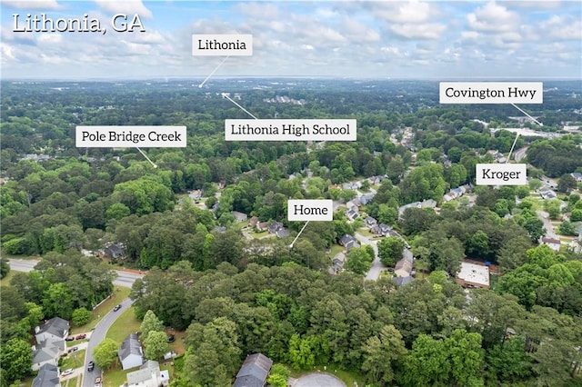 drone / aerial view featuring a view of trees