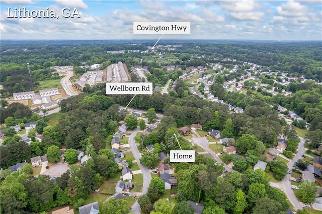 birds eye view of property featuring a view of trees and a residential view