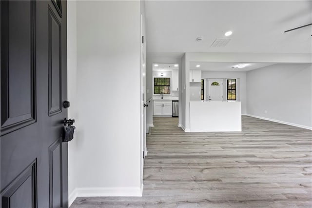 entrance foyer with baseboards, recessed lighting, and light wood finished floors