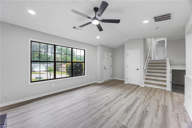 unfurnished living room with ceiling fan, visible vents, wood finished floors, and stairway