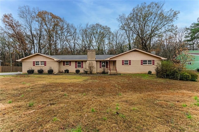 ranch-style home with a front lawn