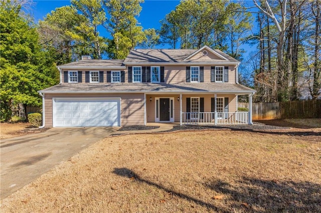 view of front of property with a garage, a front lawn, and covered porch