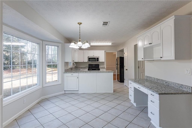 kitchen featuring white cabinetry, black refrigerator, range, and light stone counters