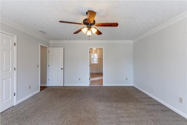 carpeted empty room featuring ceiling fan, ornamental molding, and a textured ceiling