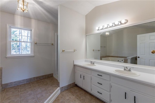 bathroom with lofted ceiling, tile patterned flooring, and vanity