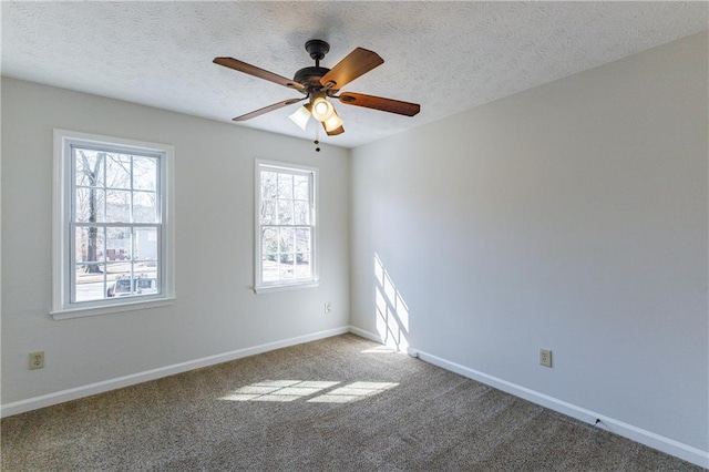 carpeted empty room with ceiling fan and a textured ceiling