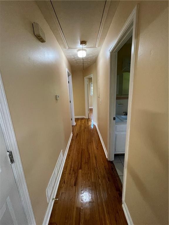 hallway with hardwood / wood-style flooring