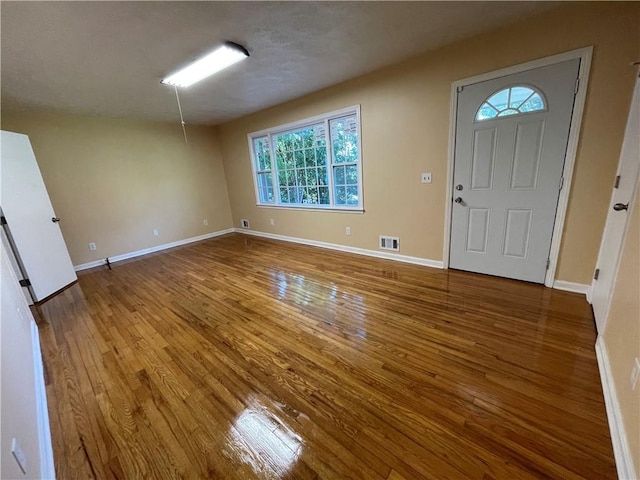 foyer entrance featuring a wealth of natural light and hardwood / wood-style floors