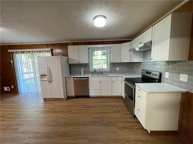 kitchen with sink, dark hardwood / wood-style flooring, white cabinets, and appliances with stainless steel finishes