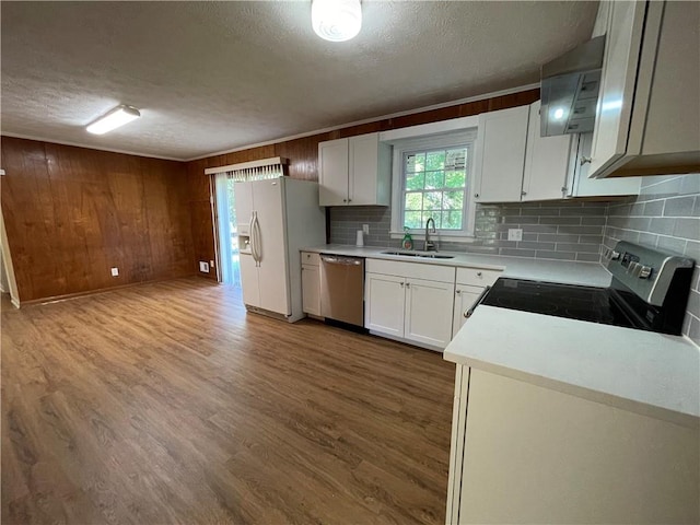 kitchen featuring sink, stainless steel dishwasher, electric range oven, and wood-type flooring