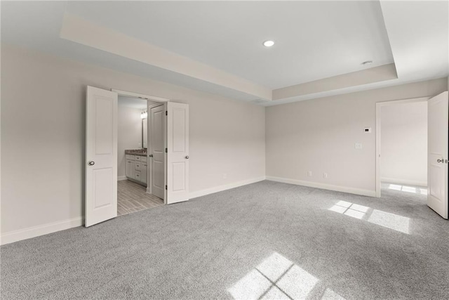 392 Brookstone Trl, Dawsonville, GA 30534 - unfurnished bedroom with recessed lighting, baseboards, light carpet, and a raised ceiling
