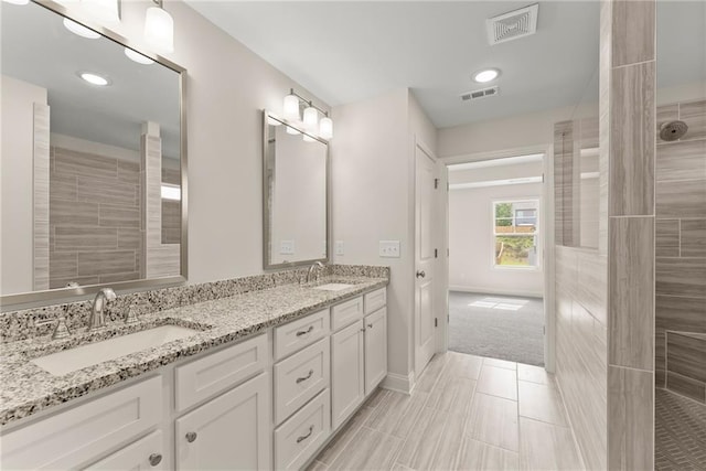 392 Brookstone Trl, Dawsonville, GA 30534 - bathroom with double vanity, visible vents, and a sink