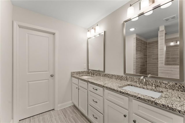 392 Brookstone Trl, Dawsonville, GA 30534 - bathroom featuring double vanity, baseboards, visible vents, and a sink
