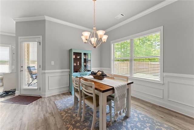 4381 Highland Gate Parkway, Gainesville, GA 30506 - dining area featuring crown molding, a notable chandelier, visible vents, and wood finished floors