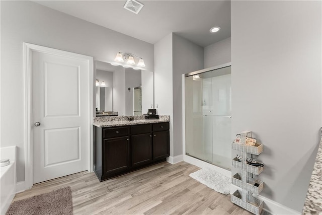 4381 Highland Gate Parkway, Gainesville, GA 30506 - full bath with visible vents, vanity, wood finished floors, and a shower stall