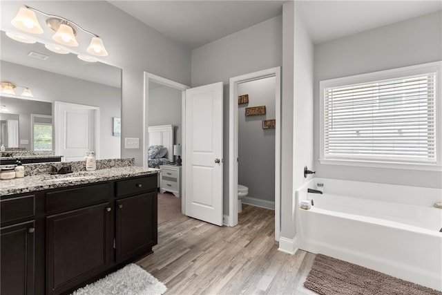 4381 Highland Gate Parkway, Gainesville, GA 30506 - ensuite bathroom with vanity, toilet, wood finished floors, visible vents, and a garden tub
