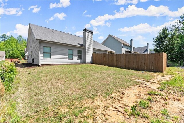 4381 Highland Gate Parkway, Gainesville, GA 30506 - rear view of house with fence, a chimney, and a lawn