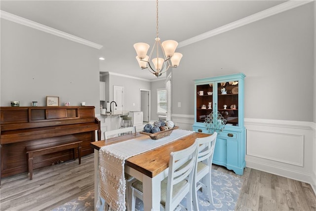 4381 Highland Gate Parkway, Gainesville, GA 30506 - dining space with crown molding, light wood-style floors, a wainscoted wall, and a notable chandelier