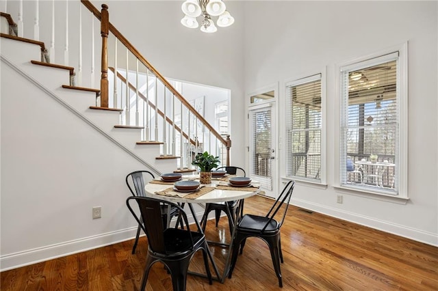 224 Celestial Ridge Dr, Dallas, GA 30132 - dining space with stairs, wood finished floors, and a chandelier