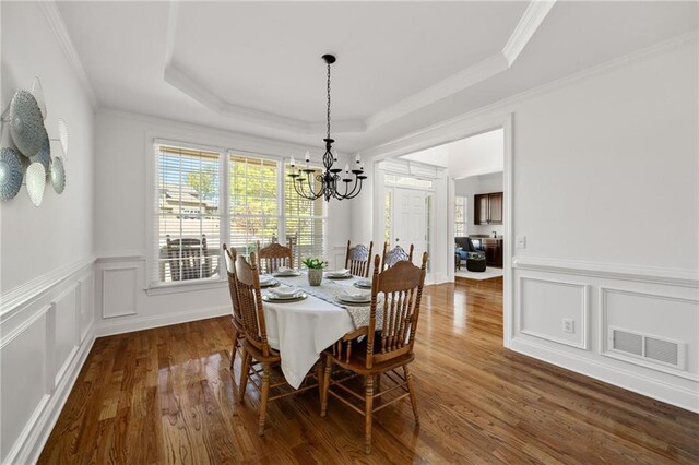 224 Celestial Ridge Dr, Dallas, GA 30132 - dining area featuring a chandelier, wood finished floors, a tray ceiling, wainscoting, and crown molding