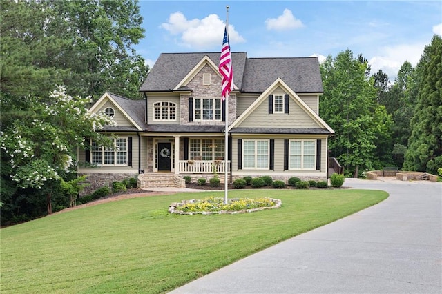 224 Celestial Ridge Dr, Dallas, GA 30132 - craftsman-style house with stone siding, a porch, a front lawn, and a shingled roof